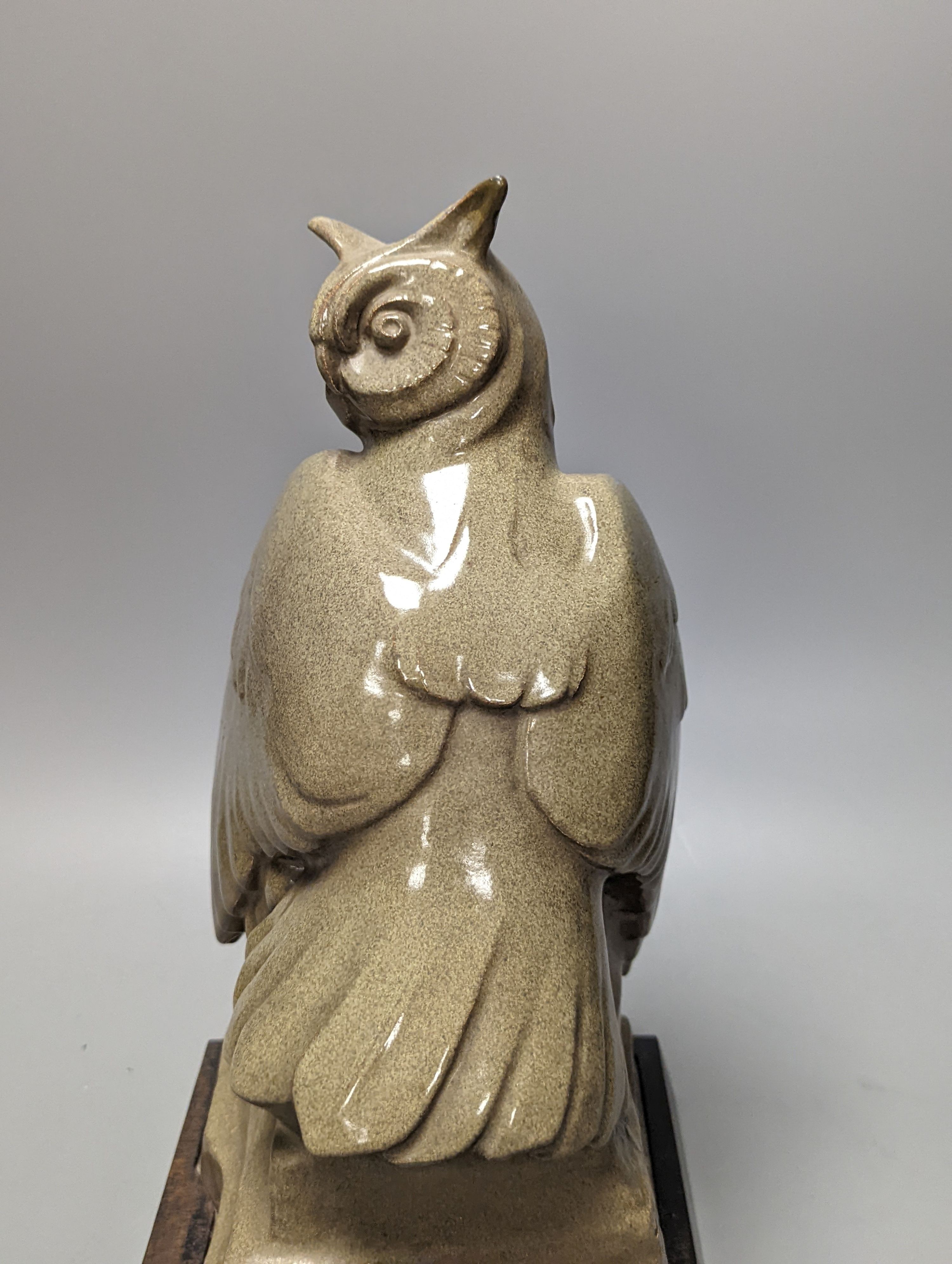 A glazed pottery owl model, 30cm, on wood plinth